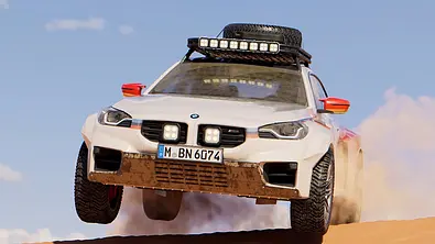 Der BMW M2 Dakar springt über eine Düne, von vorne fotografiert. - Foto: BMW M