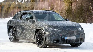 Das Mercedes-AMG SUV fährt als Erlkönig auf einer verschneiten Straße, von vorne rechts fotografiert. - Foto: SH Proshots