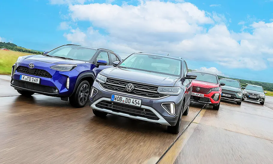 Blick von vorne auf die fahrenden City-SUV Toyota Yaris Cross, VW T-Cross, Peugeot 2008, Kia Niro und Seat Arona.