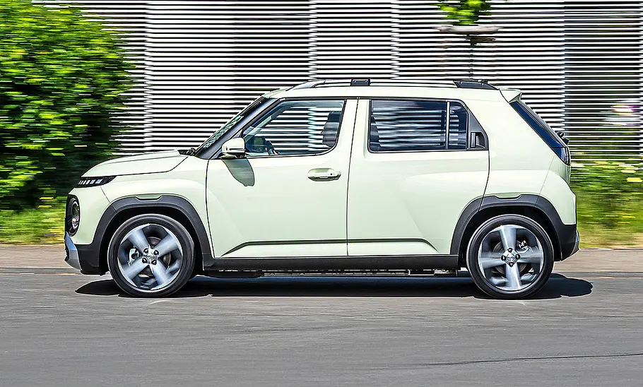 Hyundai Inster Blick von der Seite auf den fahrenden Elektro-Kleinwagen Hyundai Inster.