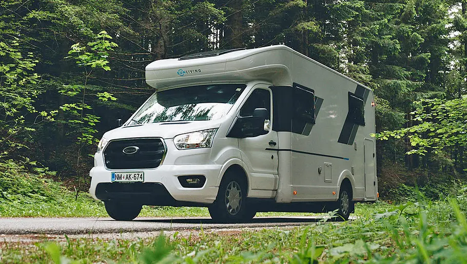 Sunliving S 72 DL Der Sunliving S 72 DL auf einem asphaltierten Waldweg zwischen Bäumen stehend von schräg vorne links.