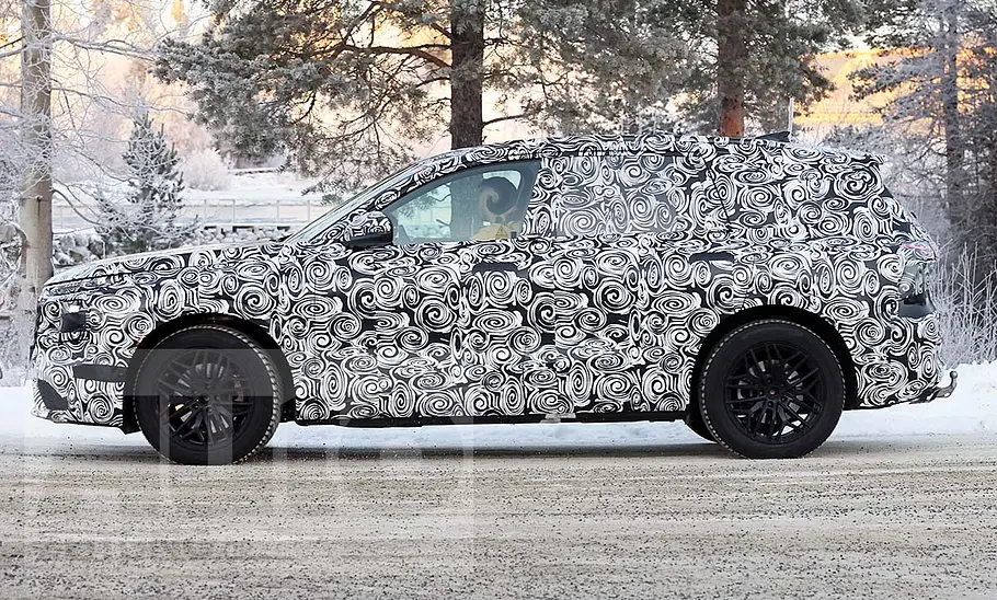 Der Audi Q7 (2025) fährt als Erlkönig durch eine verschneite Gegend; von links fotografiert.