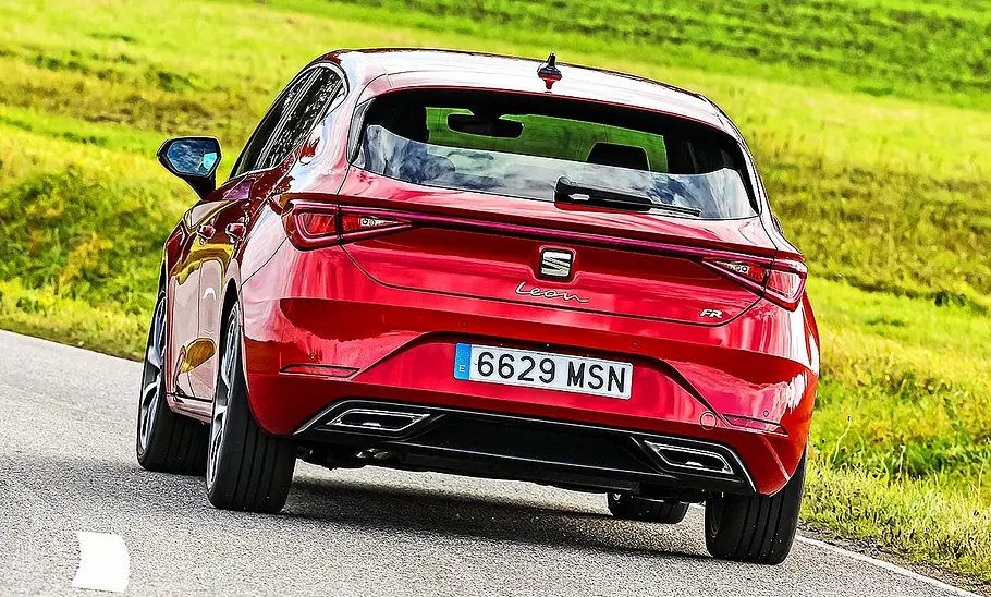 Seat Leon Blick von hinten auf den fahrenden Seat Leon auf einer Landstraße.