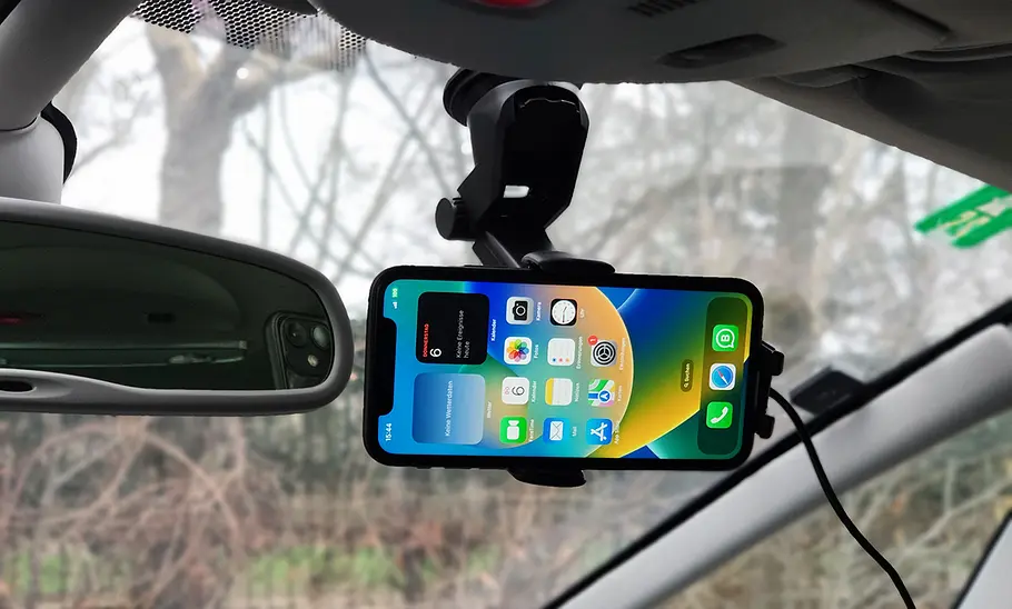 Handyhalterung fürs Auto mit Ladefunktion im Test Der Sonru Smart Wireless Charger an der Windschutzscheibe mit Handy im Querformat.