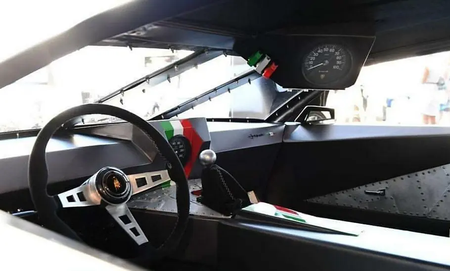 Cockpit des Lamborghini Espada von Danton Arts Kustoms mit Lenkrad, Tachometer und Drehzahlmesser, fotografiert von der Seite.