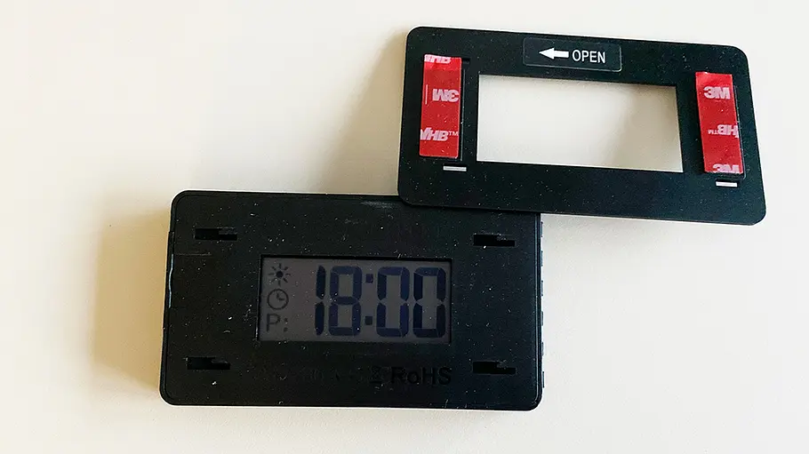 Elektronische Parkscheibe Parkwächter V1 mit Halterahmen, fotografiert von oben.