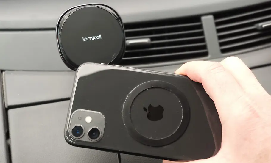 Magnetic wireless phone holder mounted on a car dashboard vent