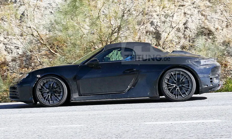 Porsche 718 Boxster Electric (2027) Blick von der Seite auf den fahrenden Erlkönig des Porsche 718 Boxster Electric (2027).