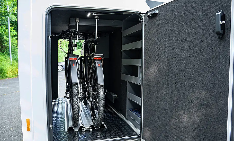 Die Heckgarage des Frankia Noctra Cruiser 7.6 (2025) mit zwei Fahrrädern durch die geöffnete rechte Garagentüre fotografiert.