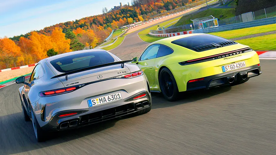 Blick von schräg hinten auf die beiden fahrenden Sportwagen Mercedes-AMG GT Pro und Porsche 911 GTS.