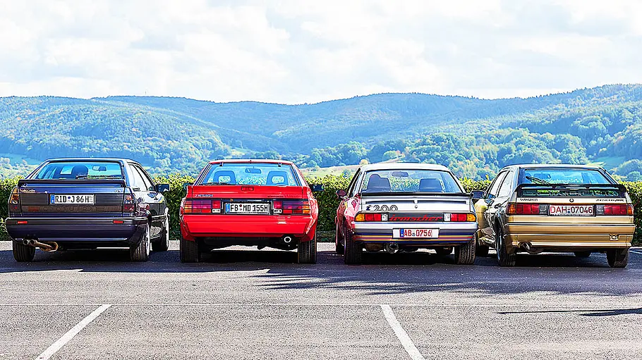 Audi Coupé/Mitsubishi Starion/Opel Manta/VW Scirocco Opel Manta, Mitsubishi Starion, Audi Coupé und VW Scirocco stehend von hinten