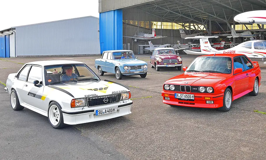 Opel Ascona 400/Alfa Romeo Giulia 1.6 TI/Borgward Isabella TS/BMW M3 (E30) Opel Ascona 400, Alfa Romeo Giulia 1.6 TI, Borgward Isabella TS und BMW M3 (E30) stehend von vorne.