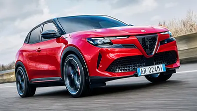 Alfa Romeo Junior Elettrica 280 Veloce (2024) auf einer Straße fahrend, Ansicht von vorne rechts. - Foto: Alfa Romeo