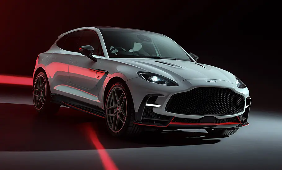 Der Aston Martin DBX S stehend von schräg vorne. Der Hintergrund ist dunkel.