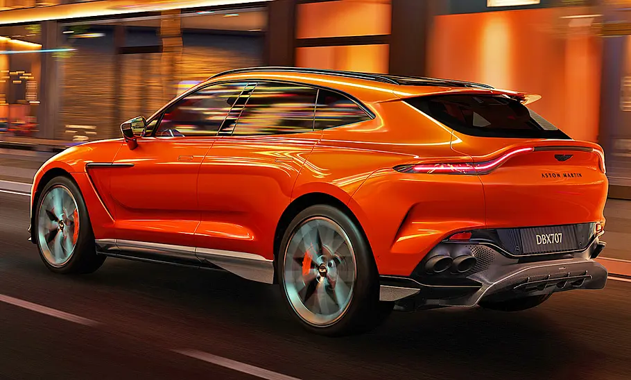 Der Aston Martin DBX707 fahrend von schräg hinten fotografiert.