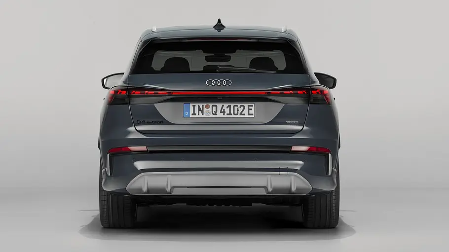 Audi Q4 e-tron Facelift Der Audi Q4 e-tron steht in Studioumgebung, von hinten fotografiert.