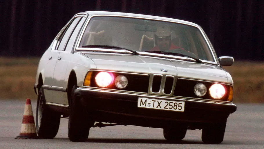 BMW 733i fahrend von schräg vorne fotografiert. 