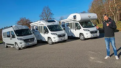 Carado CV 600, Carado T 135 und Carado A 132 stehen auf einem Parkplatz nebeneinander, Ansicht von vorne. Im Vordergrund steht eine Person. - Foto: Hardy Mutschler