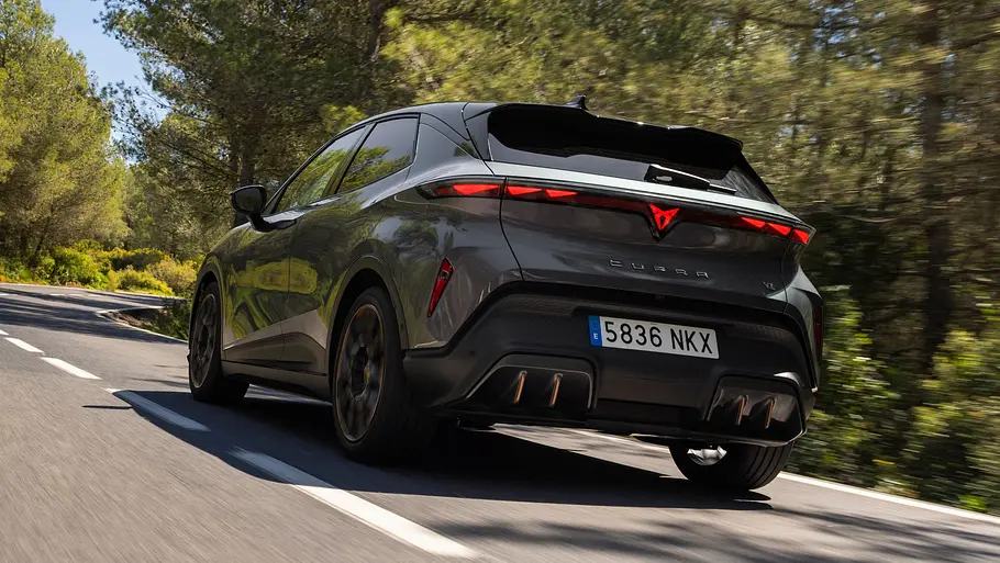 Der Cupra Raval VZ fährt auf einer Landstraße, von hinten fotografiert.