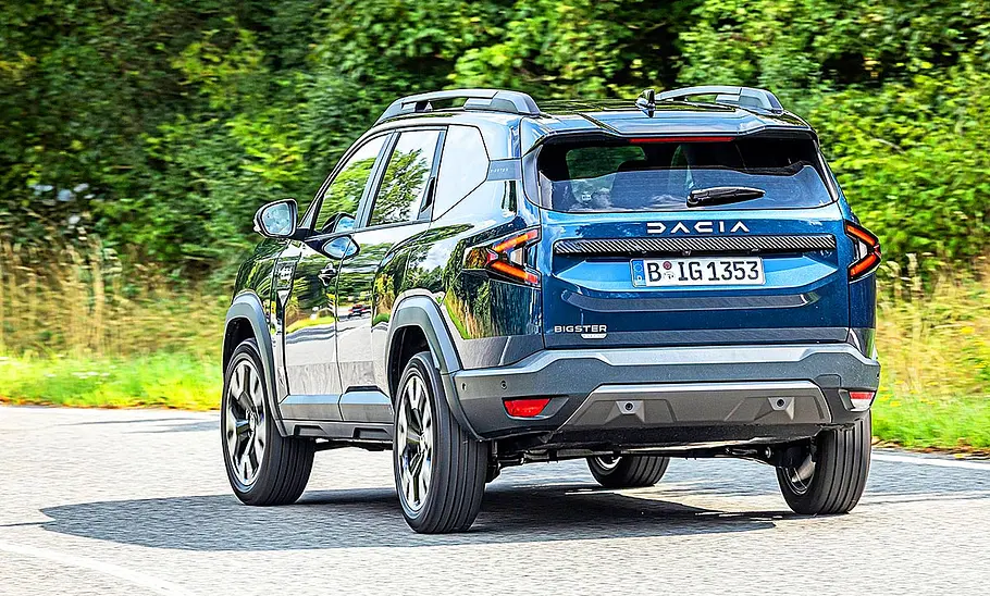 Dacia Bigster Blick von schräg hinten auf den fahrenden Dacia Bigster.