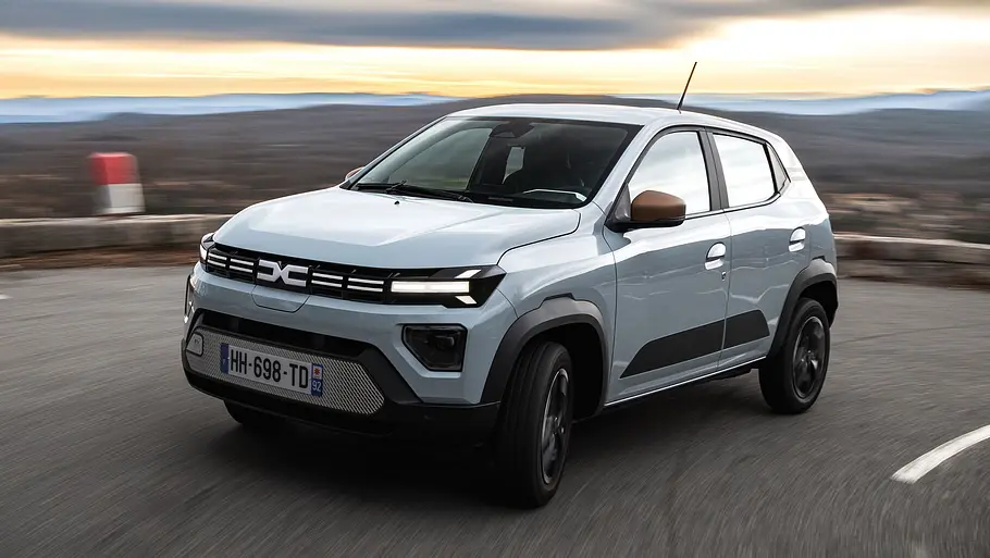 Dacia Spring (2026) Die fahrydanmische Aufnahme zeigt den Dacia Spring (2026) beim Durchfahren der Kurve einer Bergstraße.