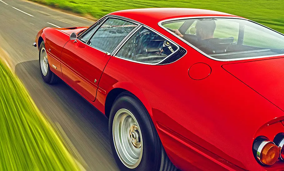 Der Ferrari 365 GTB/4 Daytona auf einer Landstraße fahrend, Ansicht von schräg hinten.