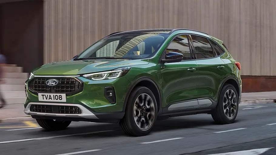 Ford Kuga Der Ford Kuga fahrend auf einer Straße.