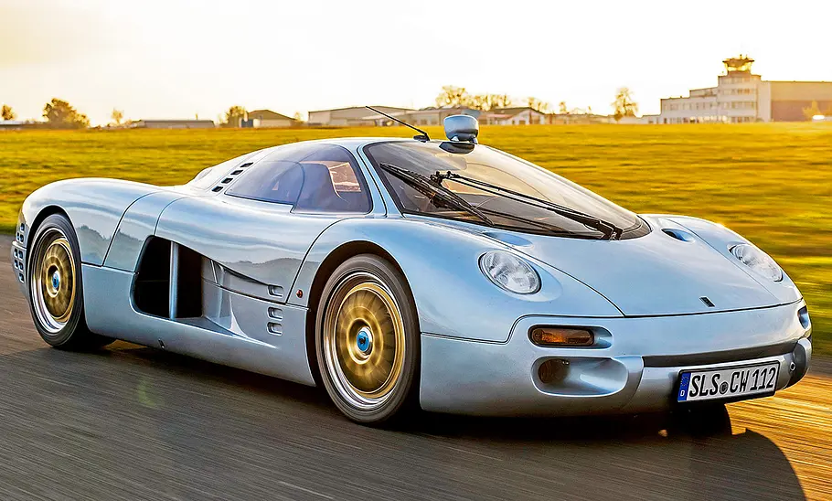 Der Isdera Commendatore fahrend von schräg vorne.