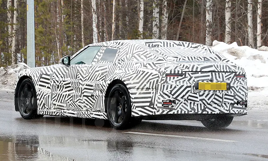Neue Markenidentität für Jaguar Ein Erlkönig des neuen Jaguar-Modells fahrend auf einer Straße von hinten.