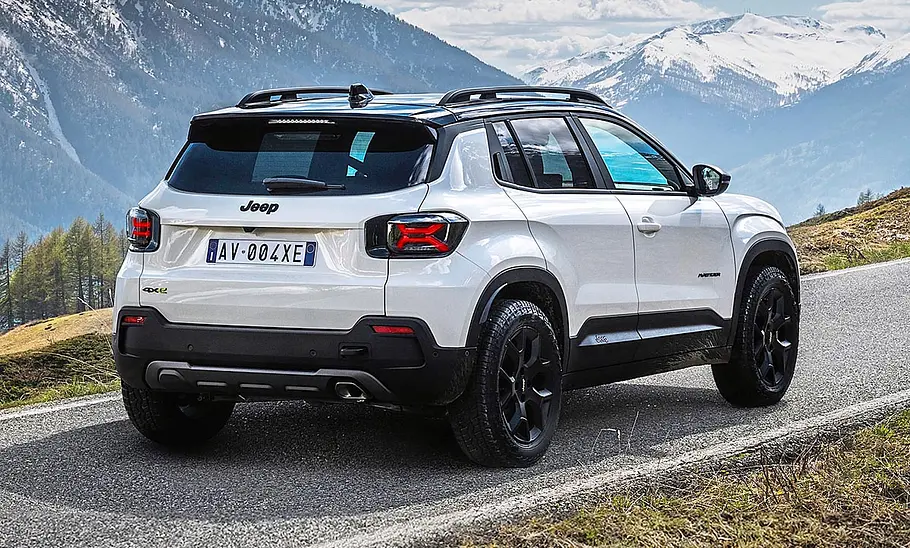 Jeep Avenger 4xe (2025) Der Jeep Avenger 4xe (2025) stehend vor einer Bergkulisse von schräg hinten fotografiert.