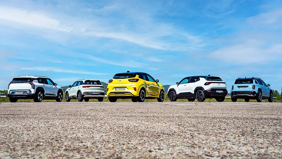 Kia EV3/BYD Atto 2/Ford Puma Gen-E/Suzuki e Vitara/Renault 4 Blick von schräg hinten auf die fünf Elektro-SUV Kia EV3, BYD Atto 2, Ford Puma Gen-E, Suzuki e Vitara und Renault 4.