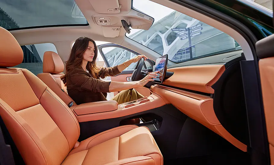 Leapmotor C10 (2024) Die Vordersitze des Leapmotor C10 (2024); eine Frau bedient den Touchscreen.