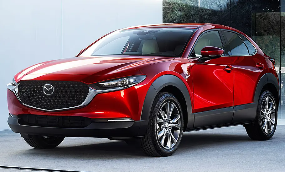 Mazda CX-30 steht vor einer Kulisse, Ansicht von vorne links.