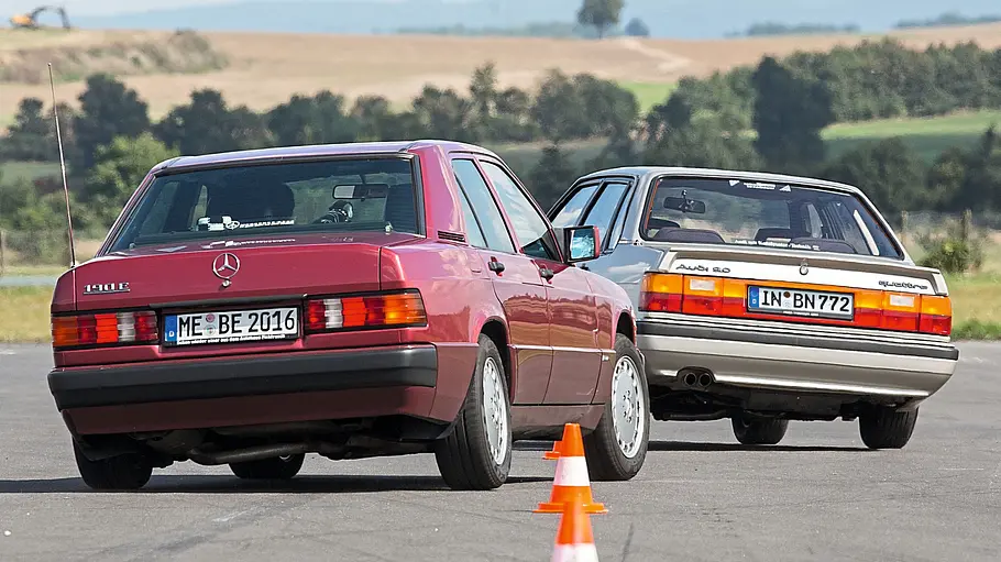 Mercedes 190 E 2.6/Audi 90 2.2 Quattro fahrend von hinten fotografiert. 