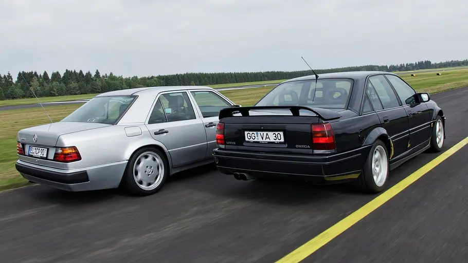 Mercedes 500 E und Opel Lotus Omega fahrend von hinten.