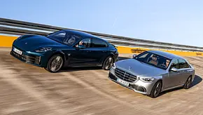 Porsche Panamera Executive und Mercedes S-Klasse Lang fahren nebeneinander durch eine Steilkurve, von vorne fotografiert. - Foto: Daniela Loof
