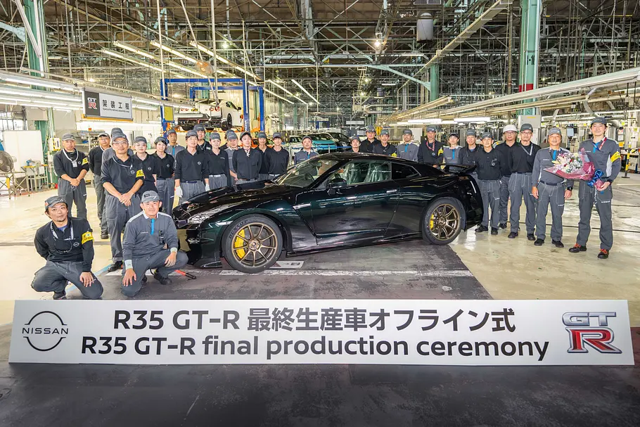 Nissan GT-R Der Nissan GT-R in einem Werk, umringt von Mitarbeitenden.