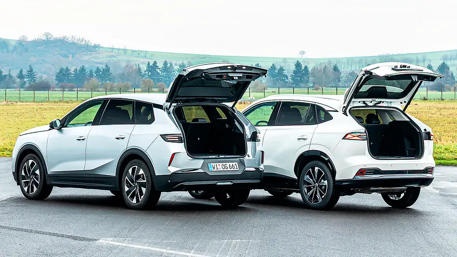 Blick von schräg hinten auf die Kompakt-SUV Opel Grandland und MG HS mit geöffnetem Kofferraum.