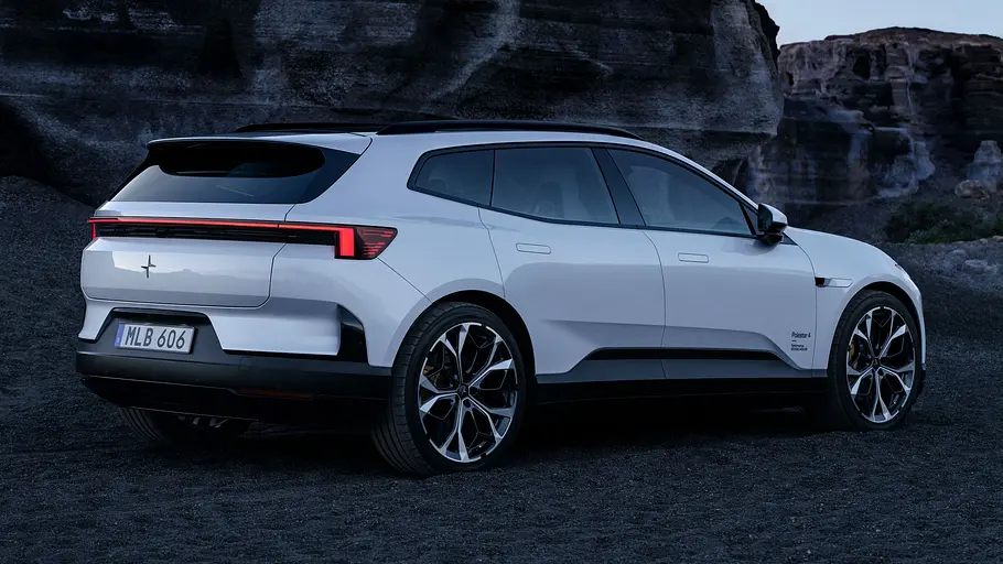 Polestar 4 SUV steht vor Felsklippen, Ansicht des Fahrzeugs von hinten rechts.