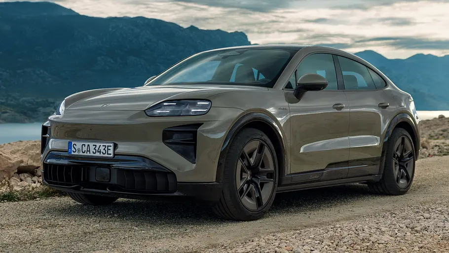 Porsche Cayenne Coupé Electric Porsche Cayenne Coupé Electric statisch auf eine Schotterstraße von vorne links fotografiert. Im Hintergrund Berge und ein großes Gewässer.