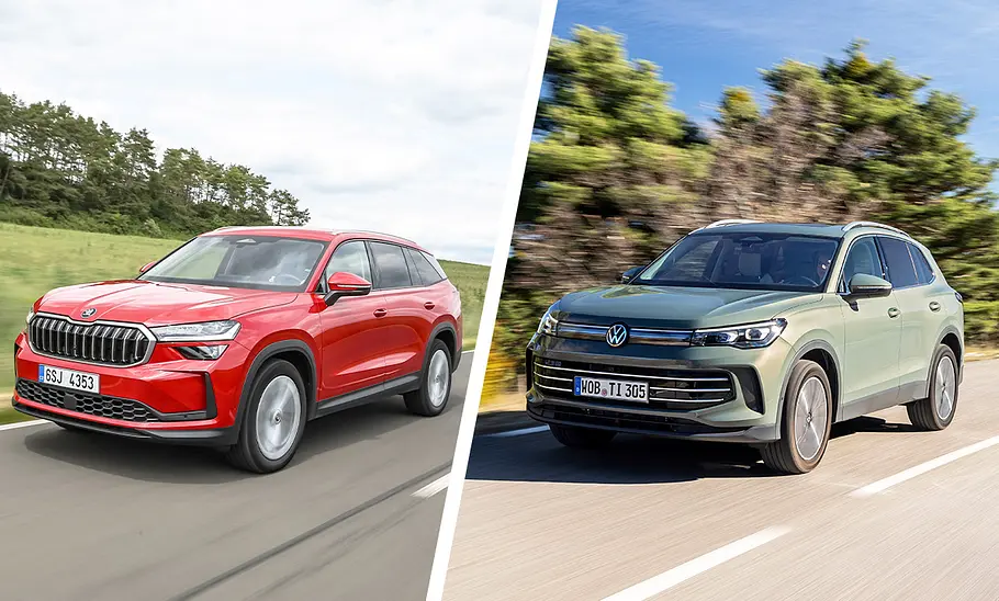 Skoda Kodiaq und VW Tiguan fahren über eine Landstraße. Sie sind von schräg vorne zu sehen.