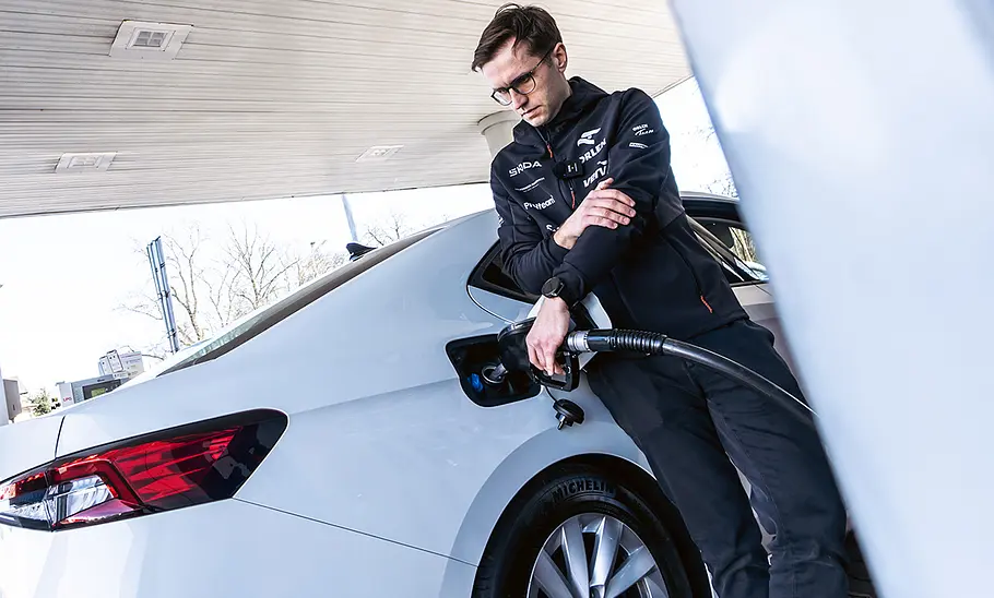 Skoda Superb Rekordfahrt Ein Mann tankt einen Skoda Superb.