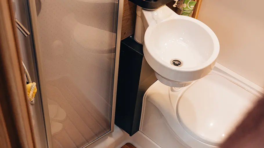Die Innenaufnahme zeigt das Klappwaschbecken und das WC im Badezimmer des Sunlight T58.