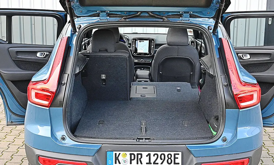 Der Kofferraum des Volvo XC40 Recharge Extended Range, zu sehen durch die geöffnete Heckklappe. Die Rücksitzbank ist zu 2/3 umgelegt.