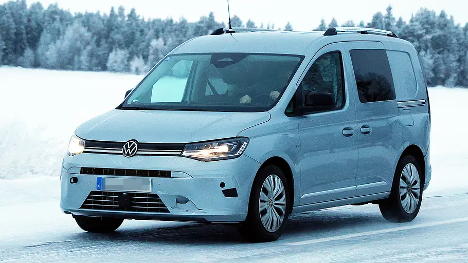Blick von schräg vorne auf den fahrenden Erlkönig des VW Caddy Facelift (2026).