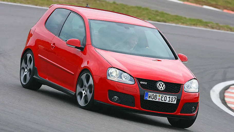 Der VW Golf 5 GTI fahrend von schräg vorne fotografiert.