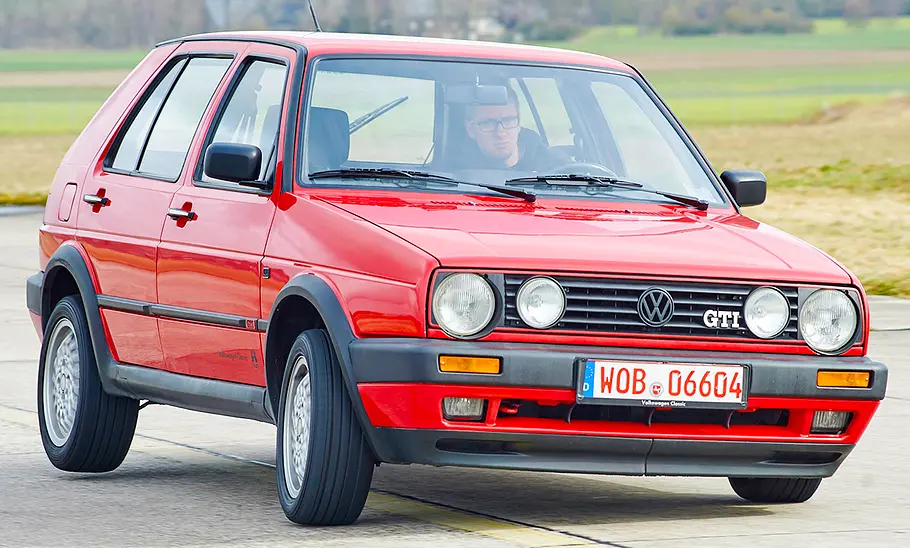 VW Golf GTI 16V fahrend von schräg vorne fotografiert.
