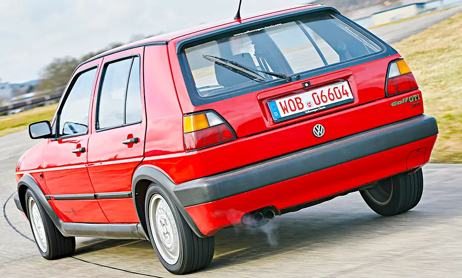 VW Golf GTI 16V fahrend von schräg hinten fotografiert.
