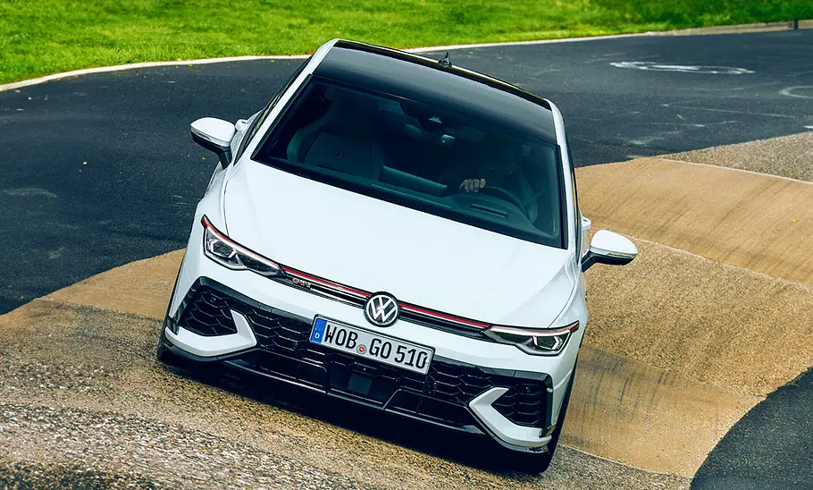 VW Golf GTI Clubsport Facelift (2024): Blick von vorne auf ein fahrendes Auto auf der Rennstrecke.