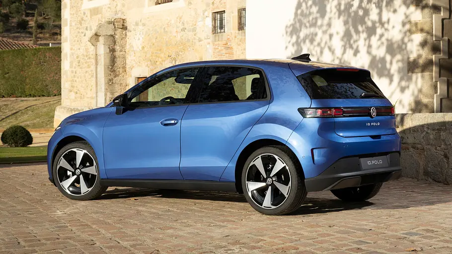 Der VW ID.Polo steht vor einem Haus, von hinten links fotografiert.